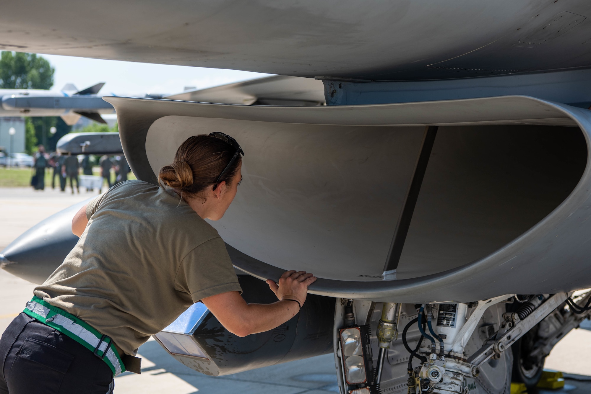 Senior Airman Brooke Parks, 555th Aircraft Maintenance Unit F-16 Fighting Falcon crew chief, inspects the intake of a U.S. Air Force F-16 during exercise Thracian Star 21 at Graf Ignatievo Air Base, Bulgaria, July 9, 2021. Out of 61 total crew chiefs in the 555th AMU, Parks is the only female crew chief who works on the flightline. (U.S. Air Force photo by Airman 1st Class Brooke Moeder)