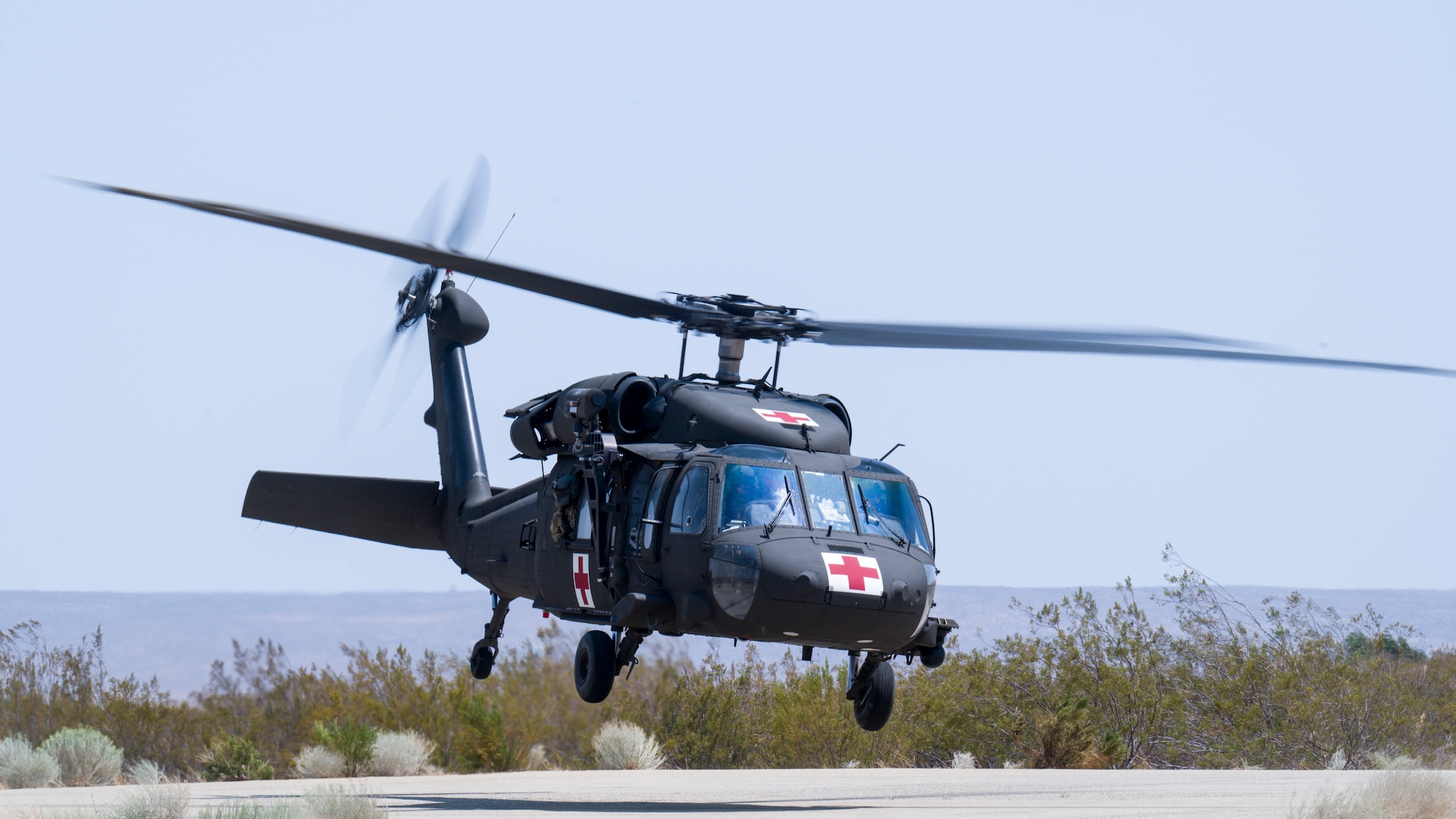 A UH-60 Blackhawk from C Company, "Desert Dustoff," 2916th Aviation Battalion, 916th Support Brigade, out of Fort Irwin, takes off from the base clinic's helipad during air medevac training at Edwards Air Force Base, California, July 15. Team Edwards medical personnel were trained on proper patient loading procedures and were then given familiarization flights around the medical facility. (Air Force photo by Giancarlo Casem)