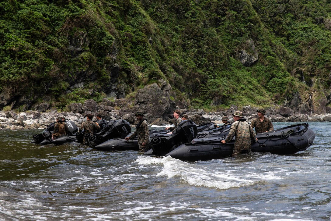 U.S. Marines with 3d Battalion, 3d Marines, move combat rubber raiding crafts