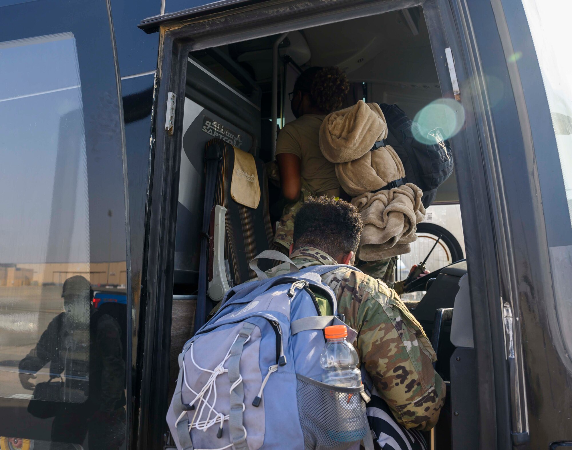 Airmen from the District of Columbia Air National Guard’s 113th Wing, known as the “Capital Guardians,” board a bus to in-process at Prince Sultan Air Base, Kingdom of Saudi Arabia, July 11, 2021. The wing deployed a contingent of U.S. Air Force F-16 Fighting Falcons to PSAB to reinforce the base’s defensive capabilities, provide operational depth, and support U.S. Central Command operations in the region. (U.S. Air Force Photo by Senior Airman Samuel Earick)