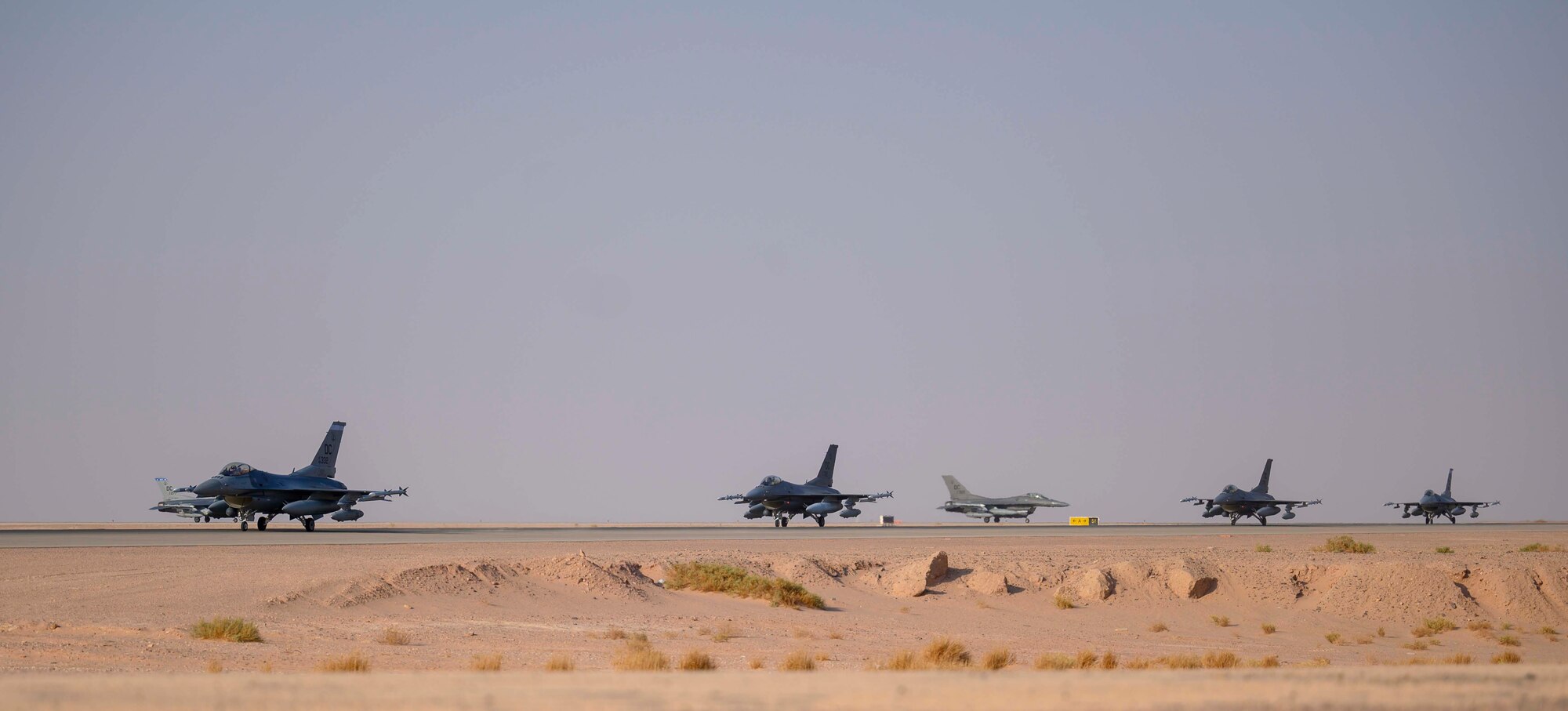 Several U.S. Air Force F-16C Fighting Falcons from District of Columbia Air National Guard’s 113th Wing, known as the “Capital Guardians,” taxi on the flight line upon arrival at Prince Sultan Air Base, Kingdom of Saudi Arabia, July 9, 2021. The wing deployed a contingent of F-16s to PSAB to reinforce the base’s defensive capabilities, provide operational depth, and support U.S. Central Command operations in the region. (U.S. Air Force Photo by Senior Airman Samuel Earick)