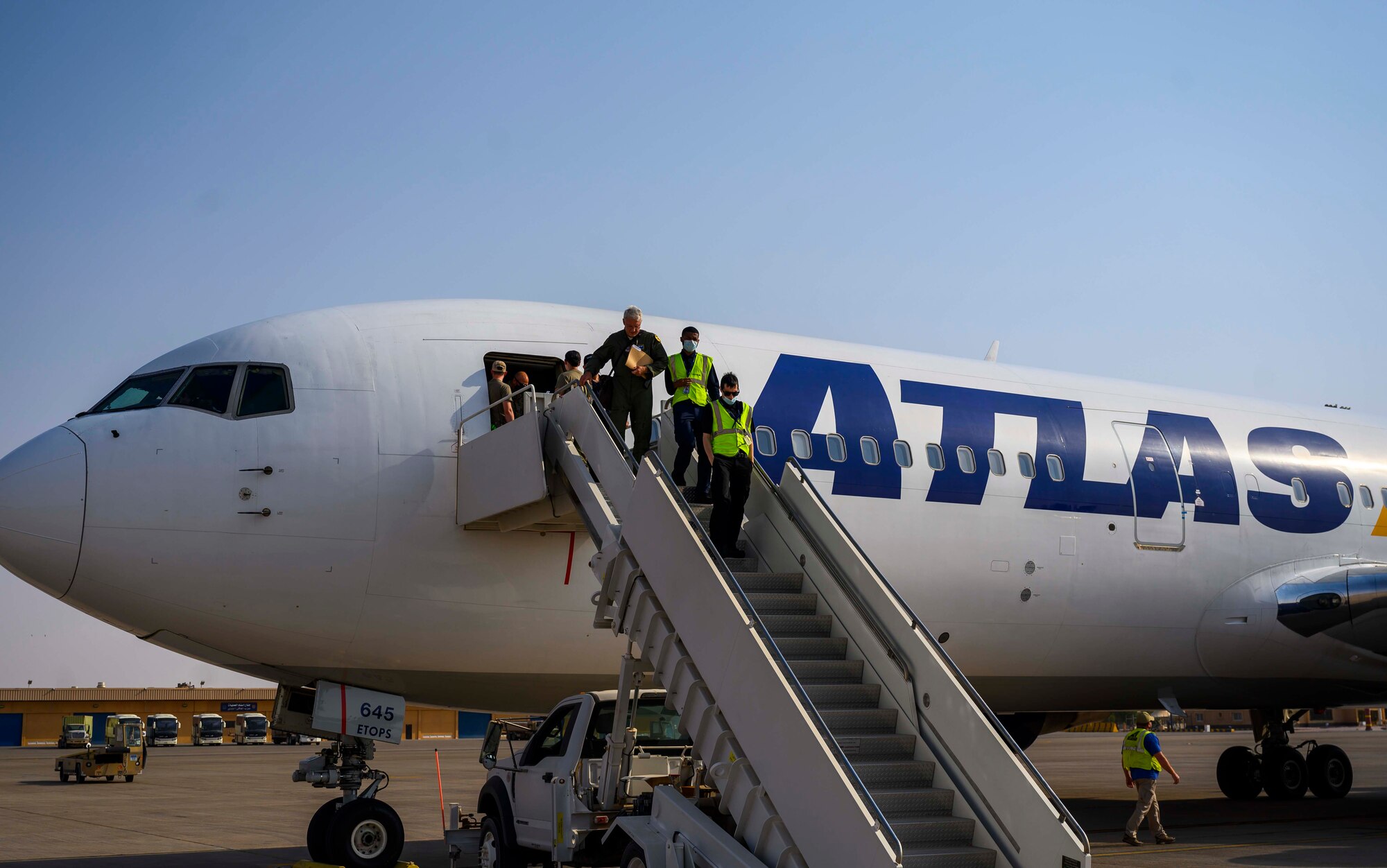 Members of the District of Columbia Air National Guard’s 113th Wing, known as the “Capital Guardians,” exit the aircraft after arriving at Prince Sultan Air Base, Kingdom of Saudi Arabia, July 11, 2021. The wing deployed a contingent of U.S. Air Force F-16 Fighting Falcons to PSAB to reinforce the base’s defensive capabilities, provide operational depth, and support U.S. Central Command operations in the region. (U.S. Air Force Photo by Senior Airman Samuel Earick)