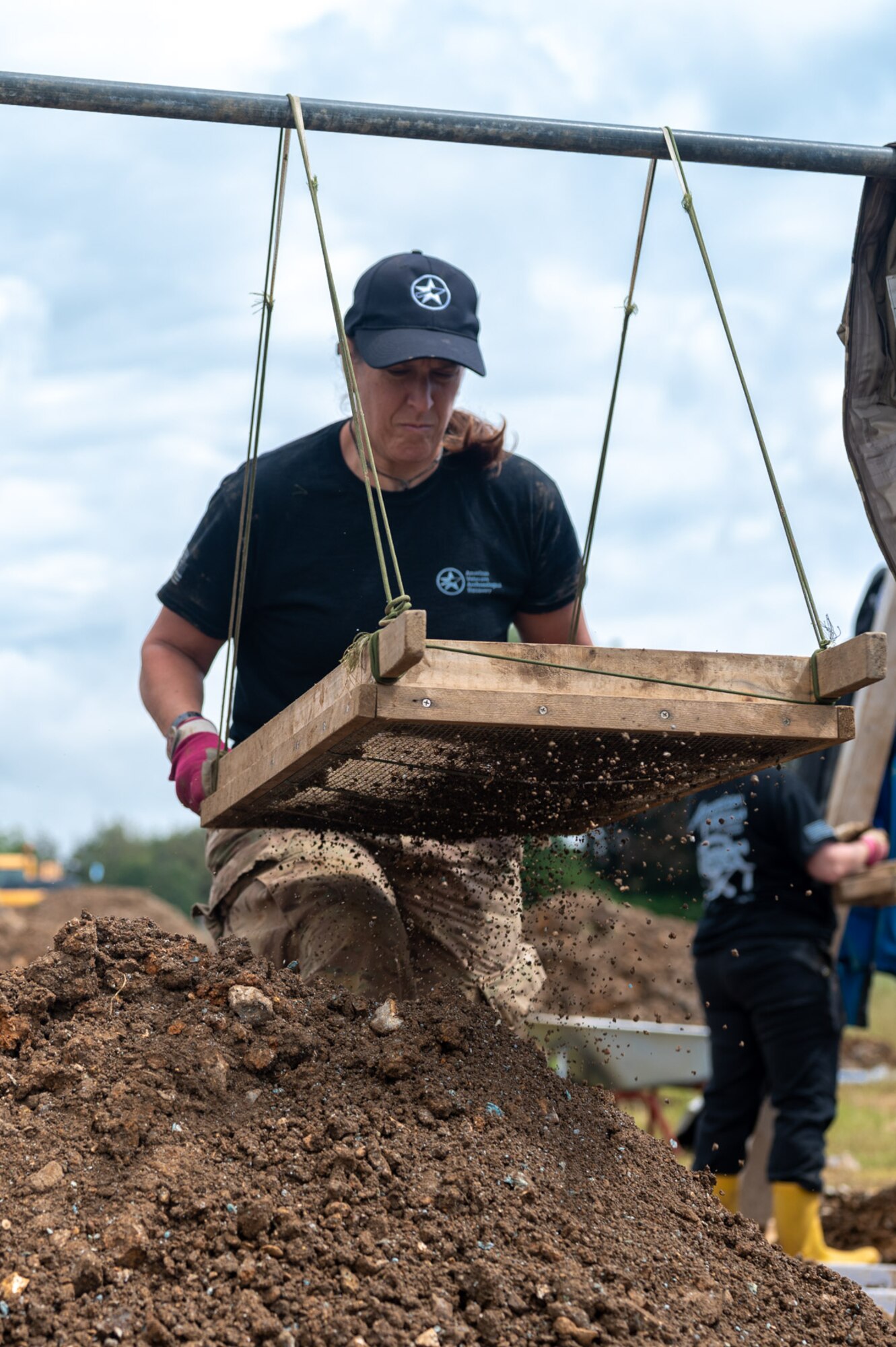 Karen Reed, a former U.S. Air Force Captain and current volunteer with the American Veterans Archeological Recovery group, searches for remains of fallen service members during a B-24 Liberator excavation at Park Farm in Arundel, England, July 8, 2021. Seven Airmen from RAF Lakenheath had the opportunity to assist in the excavation and work with the AVAR team to recover the remains of these service members. (U.S. Air Force photo by Senior Airman Koby I. Saunders)