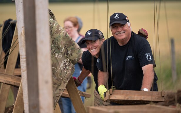 Karen Reed, a former U.S. Air Force Captain, and Peter Hay, retired British Army soldier, both volunteers with American Veterans Archaeological Recovery group, separate dirt and clay while trying to recover the remains of aircrew from a World War II era B-24 Liberator crash site at Park Farm, Arundel, England, July 8, 2021. The team was comprised of around 20 volunteers from local universities, veterans from both United States and British armed forces, and active duty service members from RAF Lakenheath. (U.S. Air Force photo by Senior Airman Koby I. Saunders)