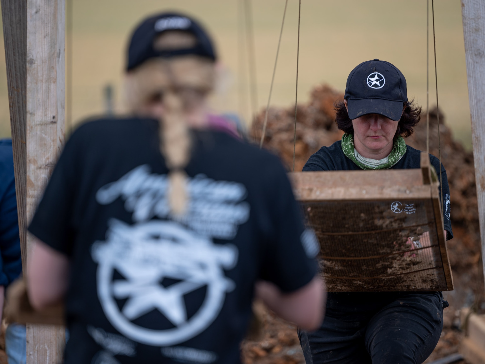 Summer Maro, a U.S. Navy veteran and volunteer with American Veterans Archaeological Recovery group, separates dirt and clay while trying to recover the remains of aircrew members from a World War II era B-24 Liberator crash site at Park Farm, Arundel, England, July 8, 2021. AVAR is conducting the dig in conjunction with the Defense POW/MIA Accounting Agency in an effort to recover those still missing in action. (U.S. Air Force photo by Senior Airman Koby I. Saunders)