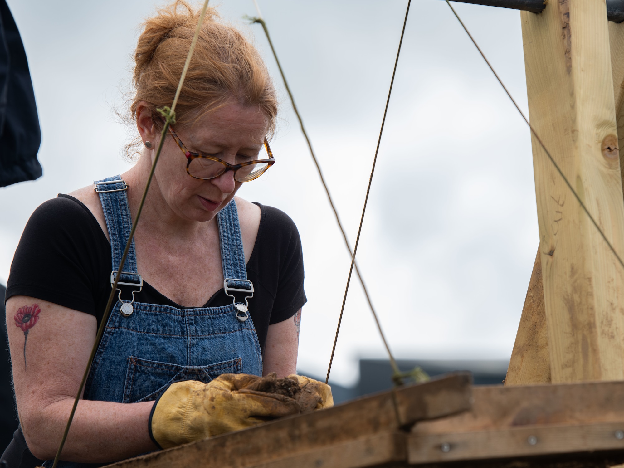 Tina Martin, a volunteer with American Veterans Archaeological Recovery, inspects samples of dirt in an attempt to recover the aircrew of a B-24 Liberator that crashed in June 1944 at Park Farm in Arundel, England, July 8, 2021. The team was comprised of around 20 volunteers from local universities, veterans from both United States and British armed forces, and active duty service members from RAF Lakenheath. (U.S. Air Force photo by Airman 1st Class Cedrique Oldaker)