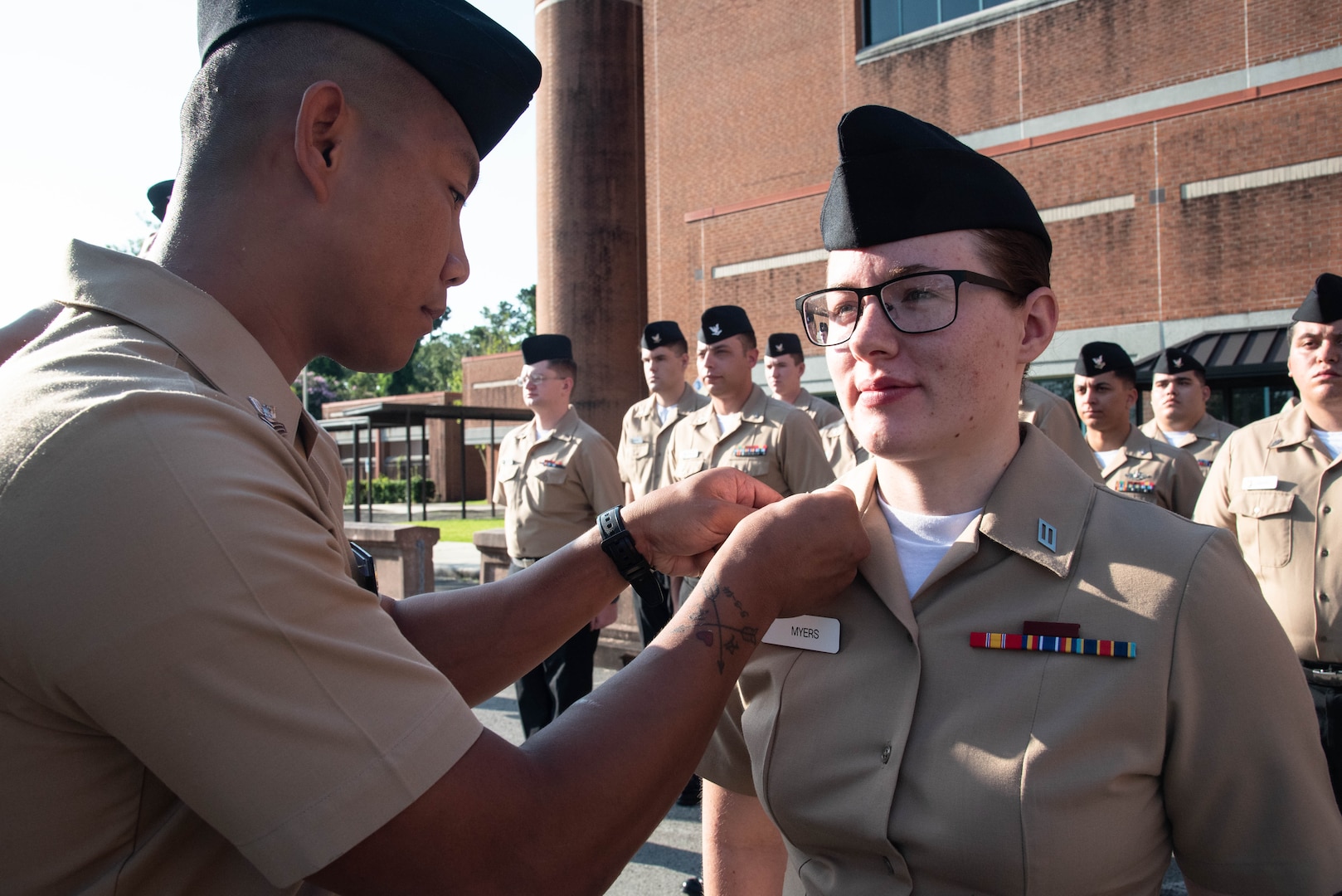 A Sailor serving aboard Naval Hospital Cherry Point pins the rank of Petty Officer Third Class upon the collar of Hospital Corpsman Third Class Kaela Myers during a frocking ceremony held aboard Marine Corps Air Station Cherry Point on Friday, July 16th.
The frocking ceremony, a tradition permitting a service member to wear rank insignia they will advance to prior to their official promotion, honored the excellence and celebrated the potential of 11 Sailors serving aboard Naval Health Clinic Cherry Point.