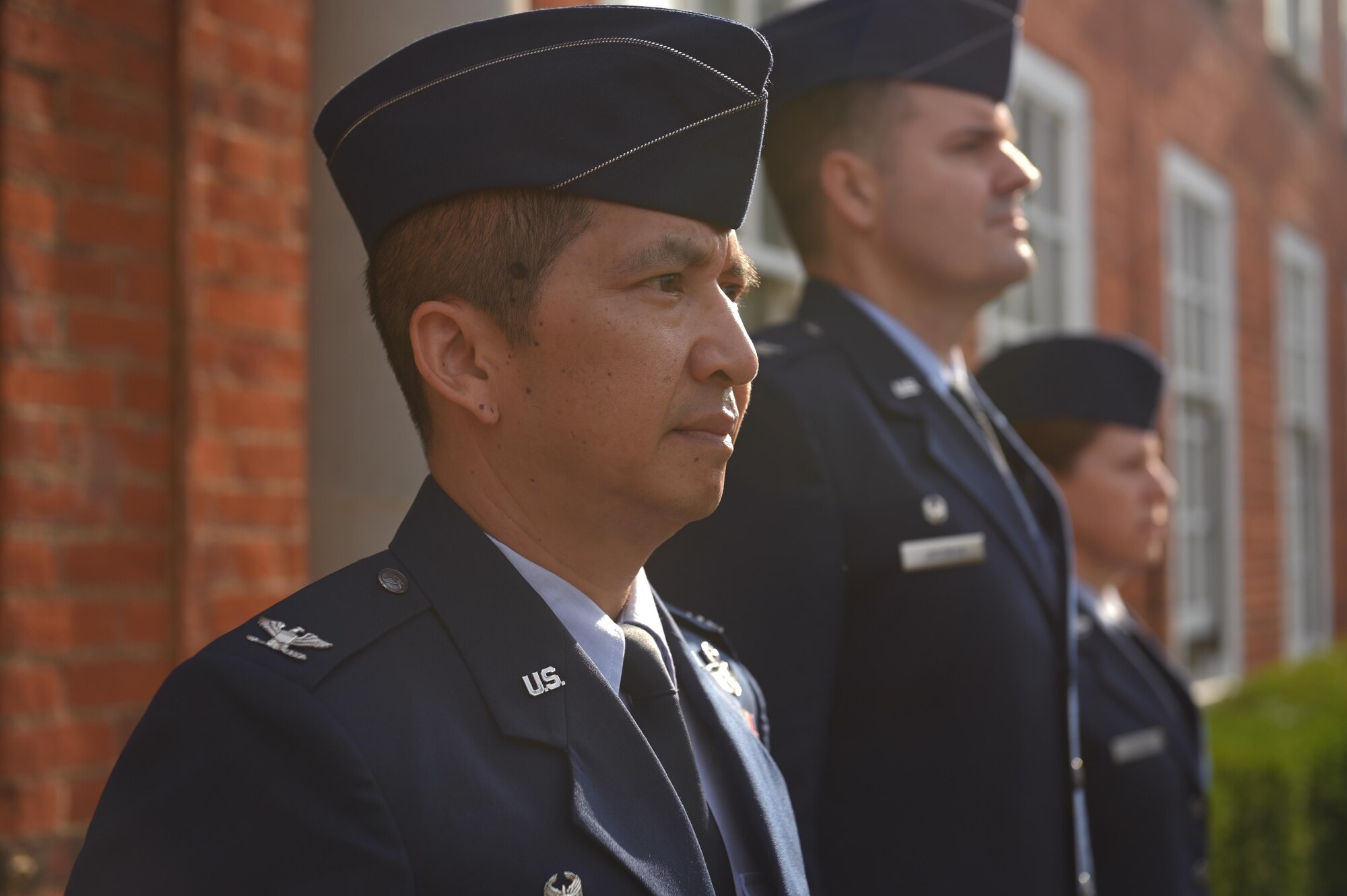 U.S. Air Force Col. Troy Pananon, 100th Air Refueling Wing commander, waits to be presented a flag at Royal Air Force Mildenhall, England, July 19, 2021. Pananon was given a flag to signify his last day as the commander of the 100th ARW. (U.S. Air Force photo by Staff Sgt. Matthew J. Wisher)