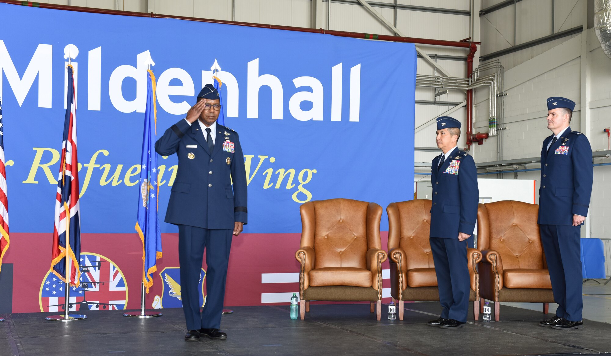 U.S. Air Force Maj. Gen. Randall Reed, left, 3rd Air Force commander, salutes the formation at the start of the 100th Air Refueling Wing change of command ceremony at Royal Air Force Mildenhall, England, July 19, 2021. Col. Troy Pananon, center, former 100th ARW commander, relinquished command to Col. Gene Jacobus. (U.S. Air Force photo by Karen Abeyasekere)