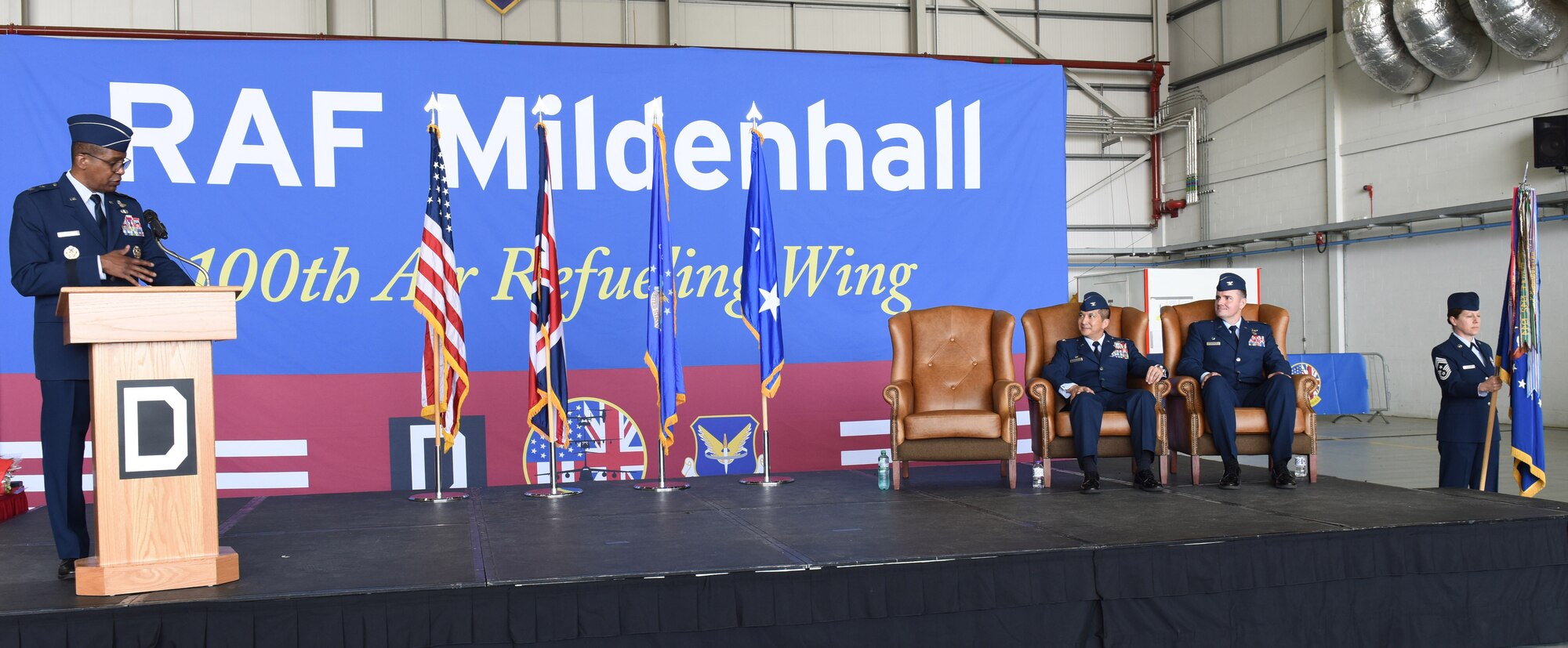 U.S. Air Force Maj. Gen. Randall Reed, left, 3rd Air Force commander, talks to the audience about the achievements of Col. Troy Pananon, center, during the 100th Air Refueling Wing change of command ceremony at Royal Air Force Mildenhall, England, July 19, 2021. Pananon relinquished command of the 100th ARW to Col. Gene Jacobus. (U.S. Air Force photo by Karen Abeyasekere)