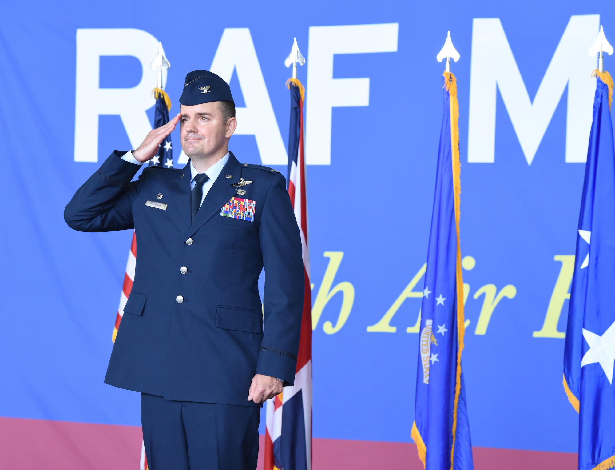 U.S. Air Force Col. Gene Jacobus, 100th Air Refueling Wing commander, gives his first salute to Airmen in the formation at the 100th ARW change of command ceremony at Royal Air Force Mildenhall, England, July 19, 2021. Jacobus was previously the vice commander of the 92nd Air Refueling Wing at Fairchild Air Force Base, Wash.(U.S. Air Force photo by Karen Abeyasekere)