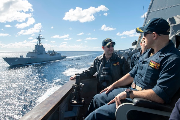 Cmdr. J.J. Murawski and Cmdr. Charles Cooper as they sail alongside the Royal Australian Navy Hobart-class air warfare destroyer HMAS Brisbane (DDG 41) during Exercise Talisman Sabre 21.