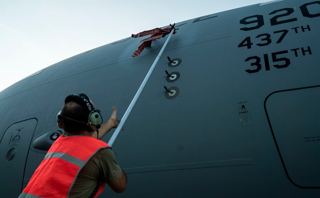 A U.S. Air Force maintainer with the 315th Airlift Wing removes a pitot tube cover.