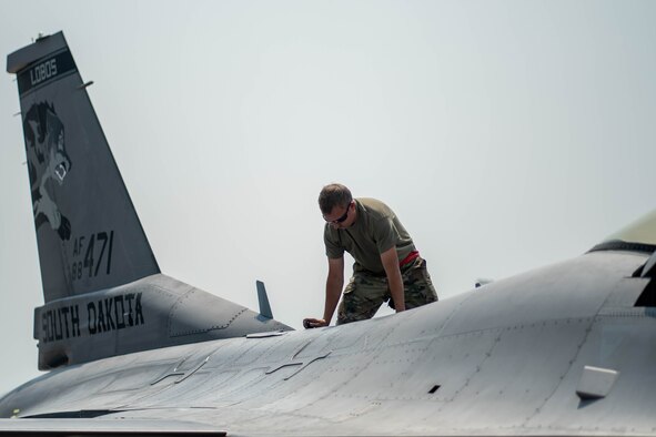 Tech Sgt. Jed Smeenk, 114th Aircraft Maintenance Squadron crew chief, goes through post-flight inspections afterthe arrival of 114th Fighter Wing F-16s at Ellsworth AFB, S.D. for exercise Combat Raider