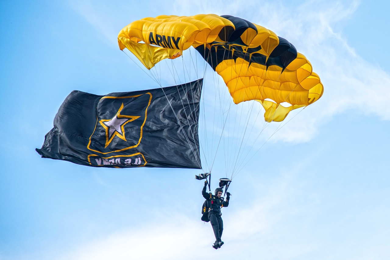 A soldier freefalls with a parachute.