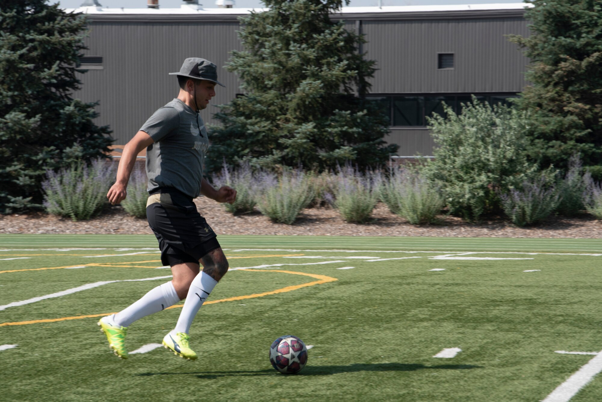 U.S. Air Force Senior Airman Robert Ramirez with the 561st Network Operations Squadron runs a soccer ball down the field at Peterson Air Force Base, Colorado, July 16, 2021.  Soccer was one of 27 events held during the Peterson AFB Sports and Field Day hosted by the 21st Force Support Squadron. (U.S. Space force photo by Airman Aaron Edwards)