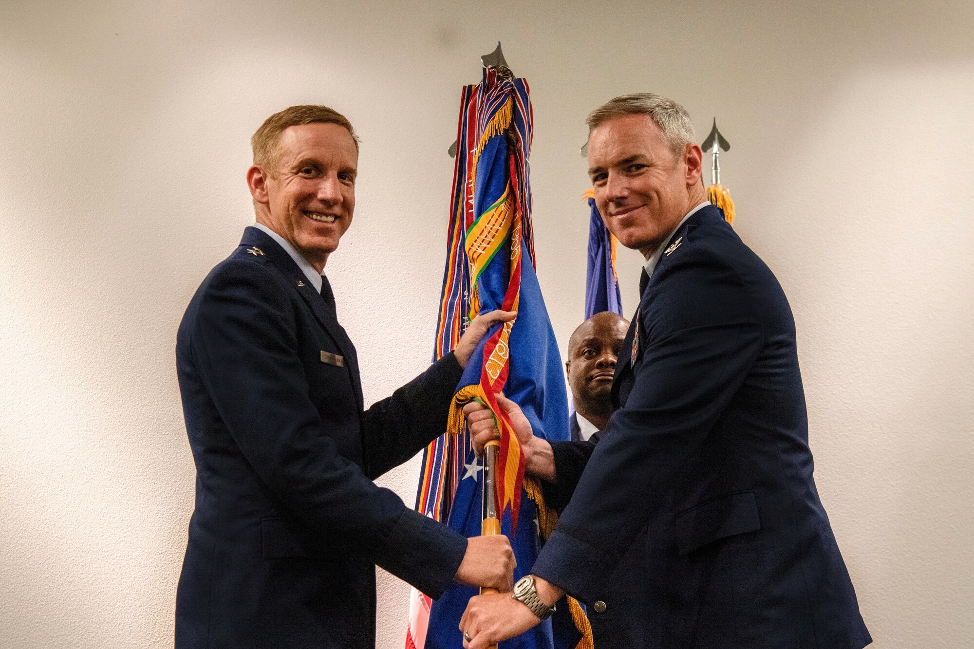 photo of Col. Fredrick Coleman III, accepting 505th Command and Control Wing guidon from Maj. Gen. Case Cunningham with Chief Master Sgt. Cornelious Thompson in the background.