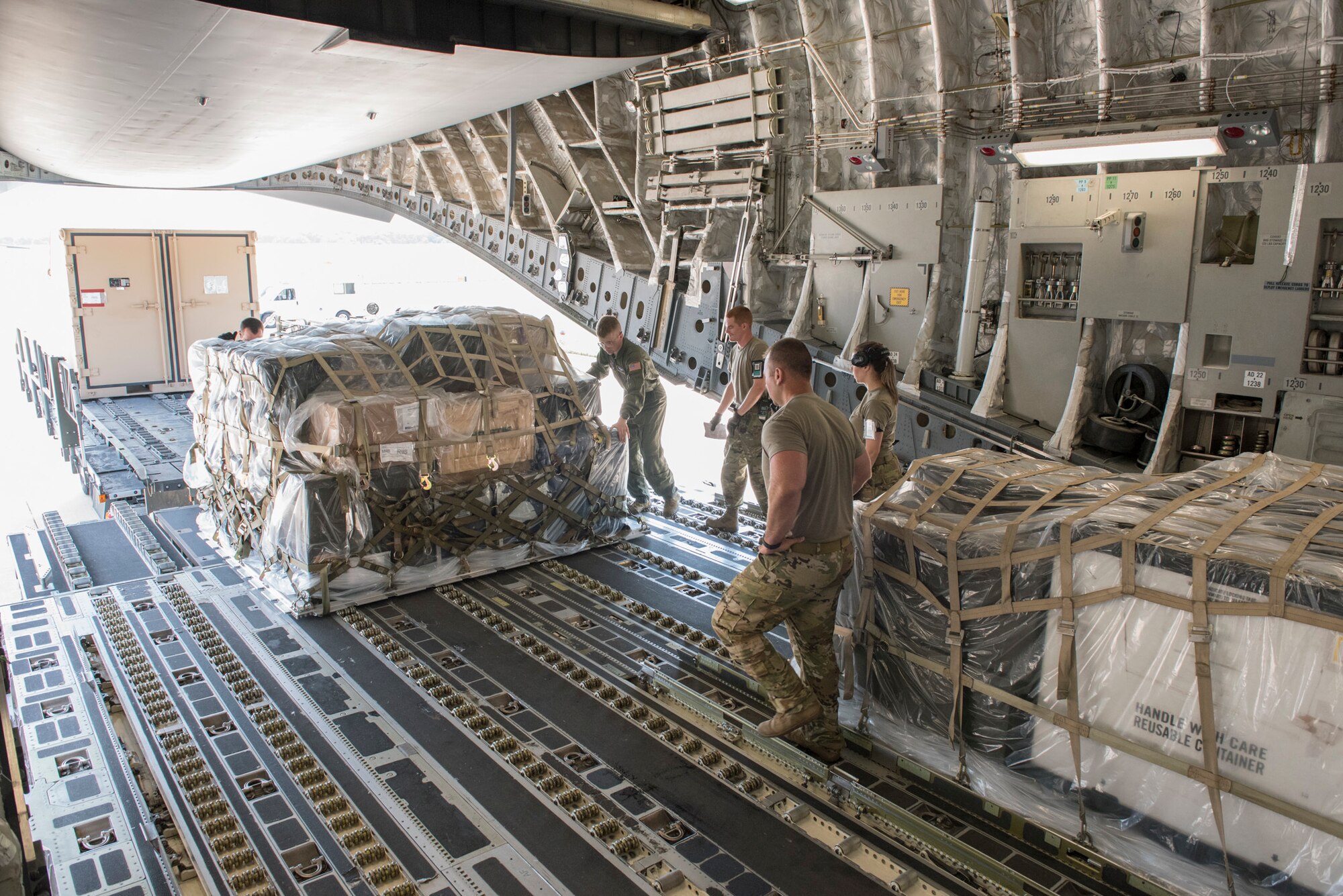 Aerial transportation specialists and loadmasters from the 167th Airlift Wing, West Virginia National Guard, and 123rd Airlift Wing, Kentucky National Guard, load palletized cargo onto a C-17 Globemaster III aircraft during a cargo loading exercise at the 167th Airlift Wing, Martinsburg, West Virginia, July 14, 2021. The 167th hosted members from the 123rd for a small air terminal training in preparation for their upcoming deployment.