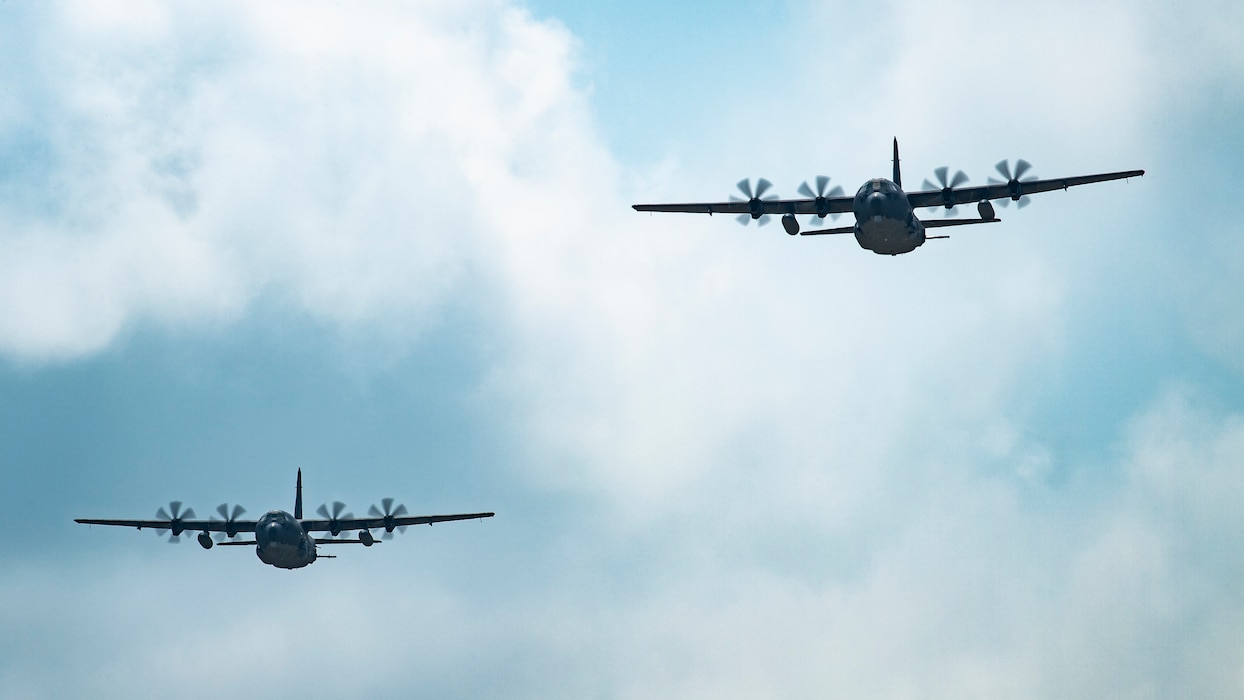 Two U.S. Air Force AC-130J Ghostriders, one assigned to the 4th Special Operations Squadron out of Hurlburt Field, Fla., and the other assigned to the 27th Special Operations Group Detachment 2, fly in formation July 19, 2021, at Cannon Air Force Base, N.M. The arrival of Cannon’s first AC-130J Ghostrider represents a significant expansion of force generation capacity as AFSOC structures for the reemergence of great power competition, tightening fiscal constraints, and the accelerating rate of technological change, demanding significant transformation to ensure Air Commandos are ready to successfully operate in this new environment. (U.S. Air Force photo by Staff Sgt. Peter Reft) (This photo has been altered for security purposes by blurring out aircraft squadron badges.)