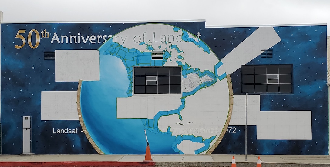 Ann Thompson, City of Lompoc Mural Society curator, started painting the earth of the mural on Ocean Avenue and I street June 27, 2021 in Lompoc, California. The mural will be implementing the history of the progression of the Landsat satellites numbers one through eight. (U.S. Space Force photo by Airman First Class Tiarra Sibley)