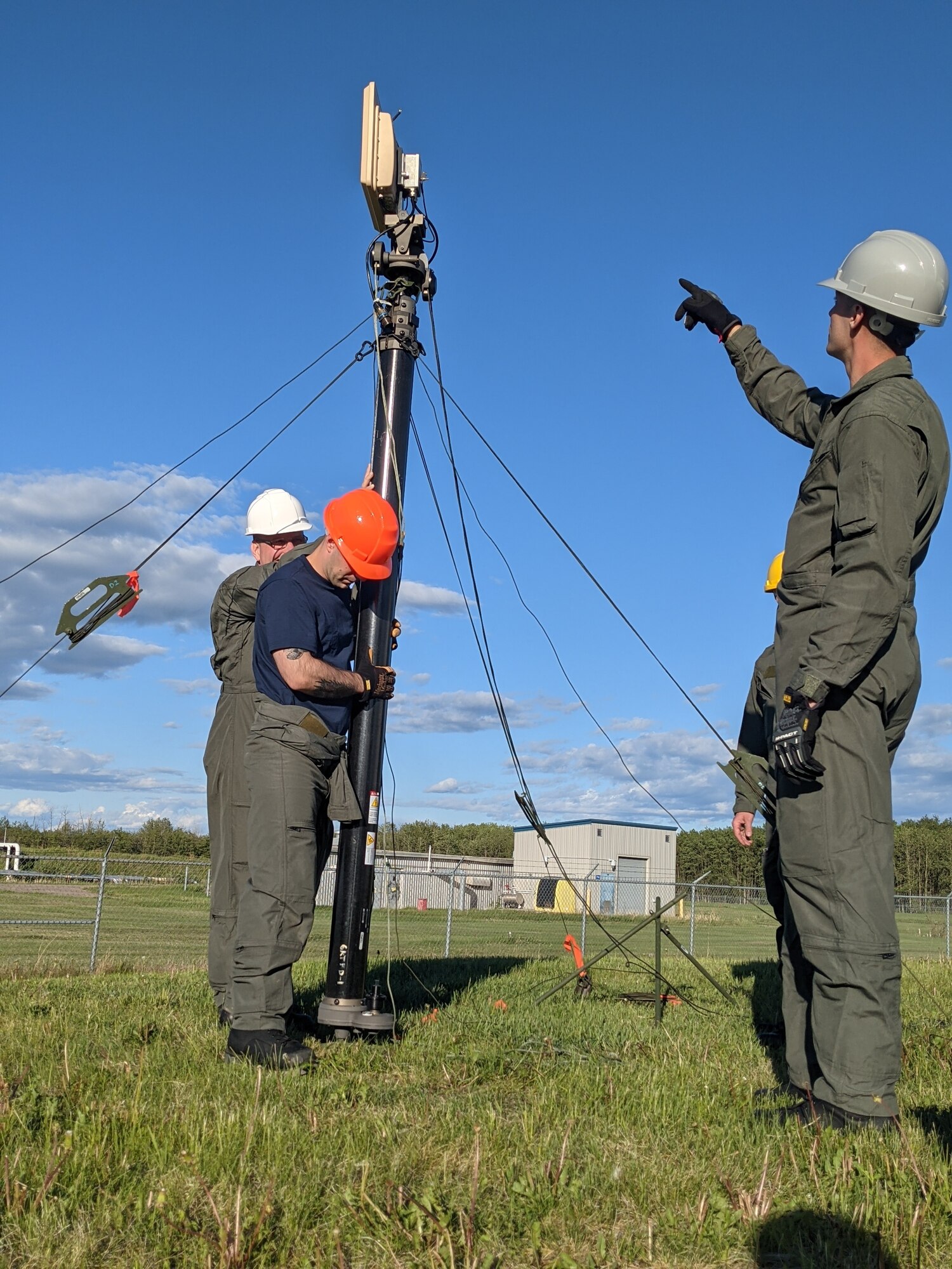 Members of the Maine Air National Guard's 265th Combat Communications Squadron install communications equipment in support of Exercise Amalgam Dart at Canadian Forces Base Cold Lake in Alberta on June 12, 2021.