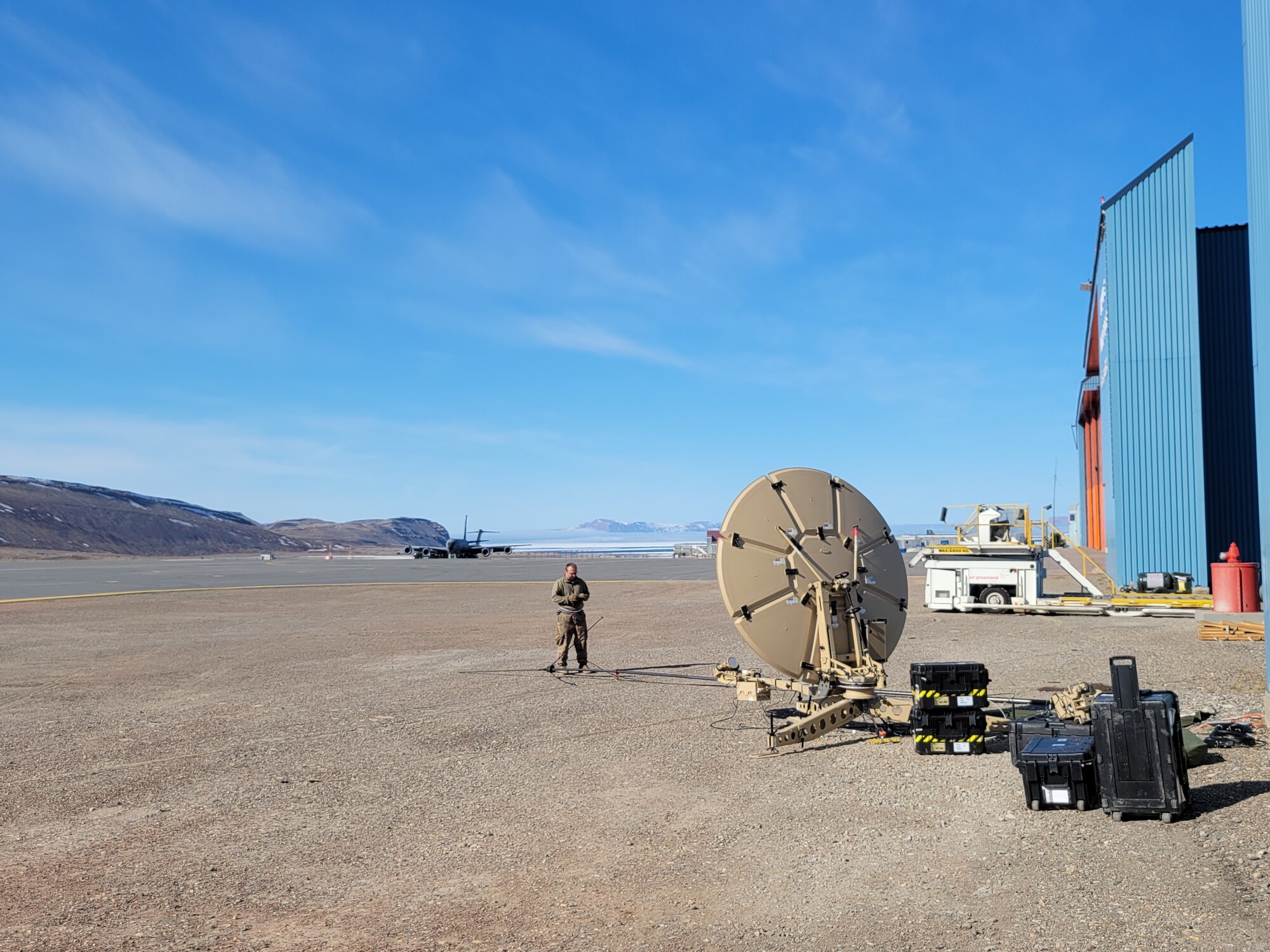 A member of the Maine Air National Guard's 265th Combat Communications Squadron supporting Exercise Amalgam Dart on June 12, 2021, at Thule Air Base in Greenland test communication equipment.
