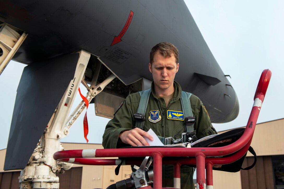Pilot reviews pre-flight checklist