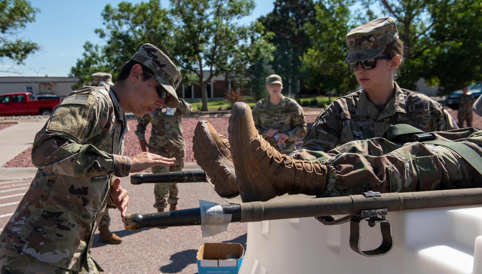 Army Sgt instructs Airmen on litter carrying