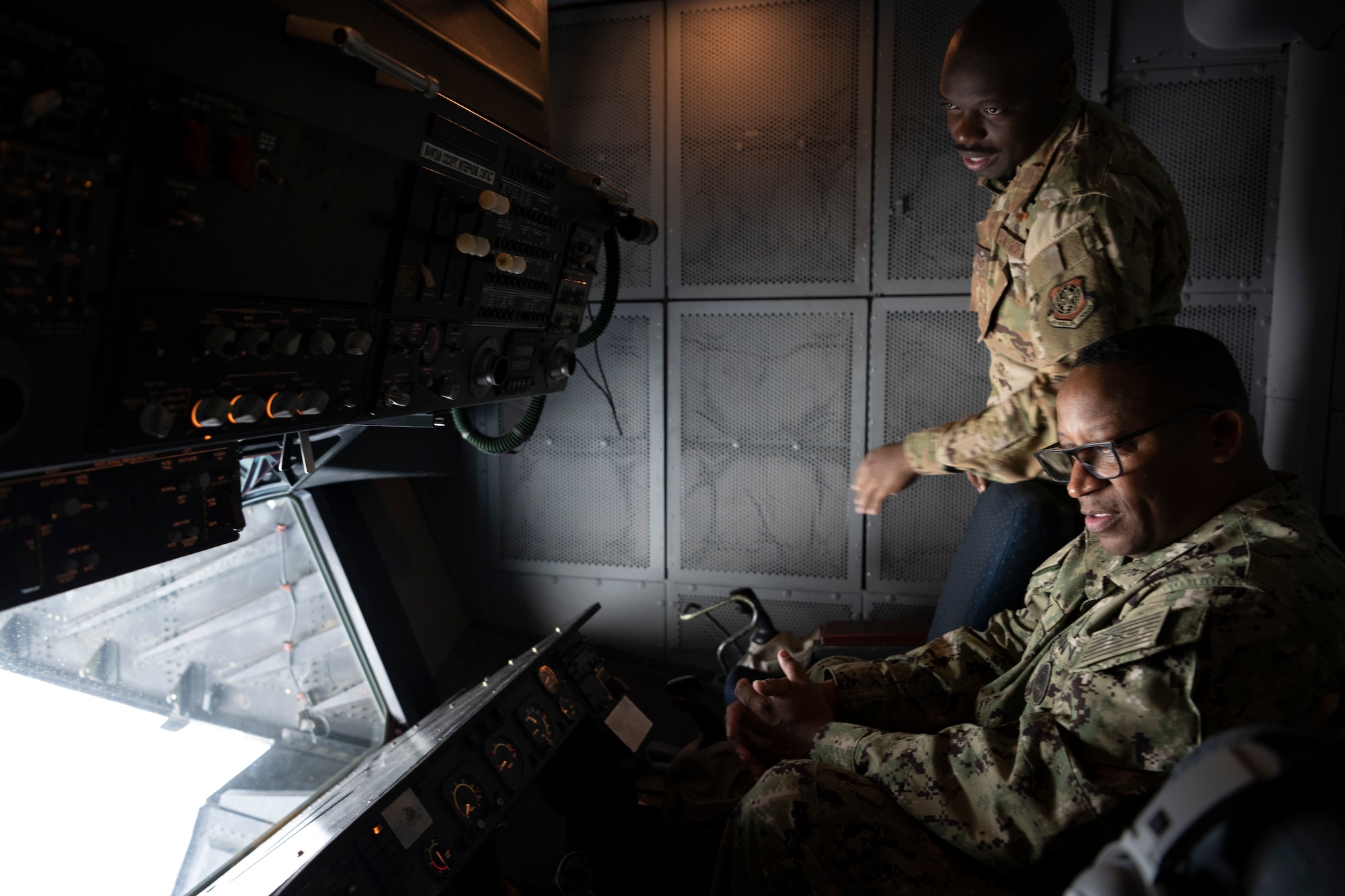 Airmen sit in a plane