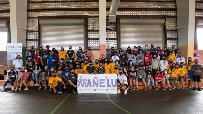 U.S. Air Force Staff Sgt. Nicholas Crisp, Mañe'lu volunteer, creates and performs a handshake dance with his group during a mentoring volunteer event at Astumbo Middle School in Dededo, Guam, July 19, 2021. Crisp and the other volunteers spent four hours with their small groups, getting to know one another and bonding during planned activities. (U.S. Air Force photo by Senior Airman Aubree Owens)