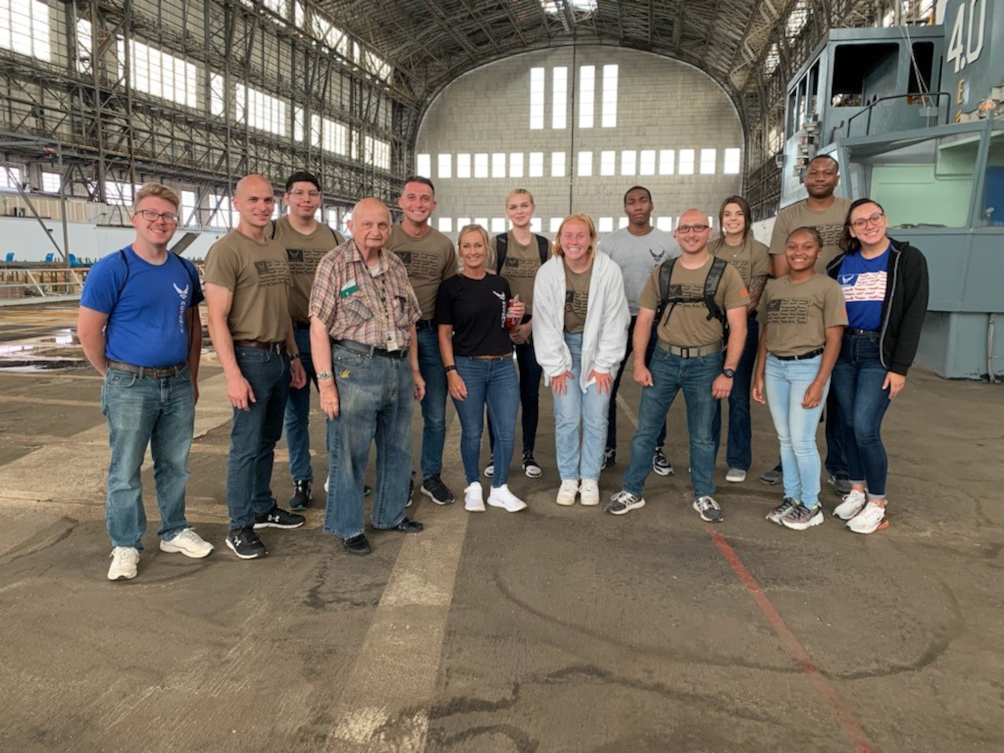 Trainees with the 514th Air Mobility Wing's Developmental Training Flight pose for a photo in Hangar One at Navy Lakehurst. The group toured the legendary Hangar One with Mr. Carl Jablonski, affectionately called Mr. Lakehurst, and Mr. Don Adams from the Navy Lakehurst Historical Society.