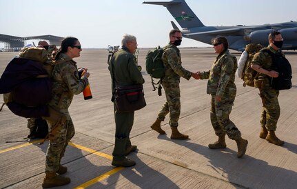 Airmen from the District of Columbia Air National Guard’s 113th Wing, known as the “Capital Guardians,” are welcomed by Lt. Col. Megan Murtishaw, 378th Air Expeditionary Operations Group deputy commander, at Prince Sultan Air Base, Kingdom of Saudi Arabia, July 11, 2021. The wing deployed a contingent of U.S. Air Force F-16 Fighting Falcons to PSAB to reinforce the base’s defensive capabilities, provide operational depth, and support U.S. Central Command operations in the region. (U.S. Air Force Photo by Senior Airman Samuel Earick)