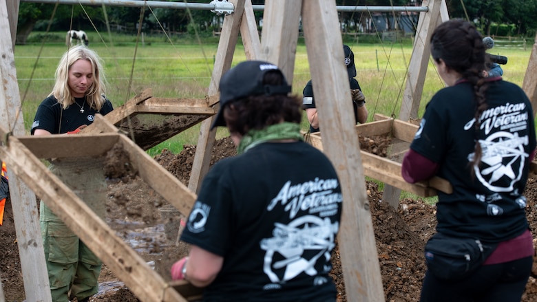 Volunteers with American Veterans Archaeological Recovery sift through dirt in an attempt to find remains of B-24 Liberator aircrew at a crash site from World War II at Park Farm, Arundel, England, July 8, 2021. Seven Airmen from RAF Lakenheath had the opportunity to assist in the excavation and work with the AVAR team to recover the remains of these service members. (U.S. Air Force photo by Airman 1st Class Cedrique Oldaker)