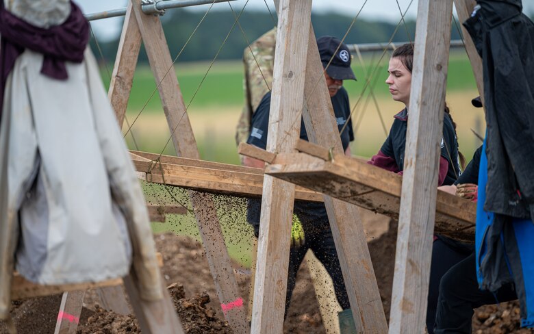 Volunteers with the American Veterans Archeological Recovery group search for remains of fallen service members during a B-24 Liberator excavation at Park Farm in Arundel, England, July 8, 2021. Seven Airmen from RAF Lakenheath had the opportunity to assist in the excavation and work with the AVAR team to recover the remains of these service members. (U.S. Air Force photo by Senior Airman Koby I. Saunders)