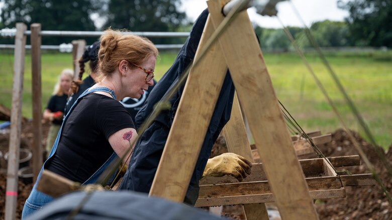 Tina Martin, a volunteer for the American Veterans Archeological Recovery group, searches for remains of fallen service members during a B-24 Liberator excavation at Park Farm in Arundel, England, July 8, 2021. The team was comprised of around 20 volunteers from local universities, veterans from both United States and British armed forces, and active duty service members from RAF Lakenheath. (U.S. Air Force photo by Senior Airman Koby I. Saunders)