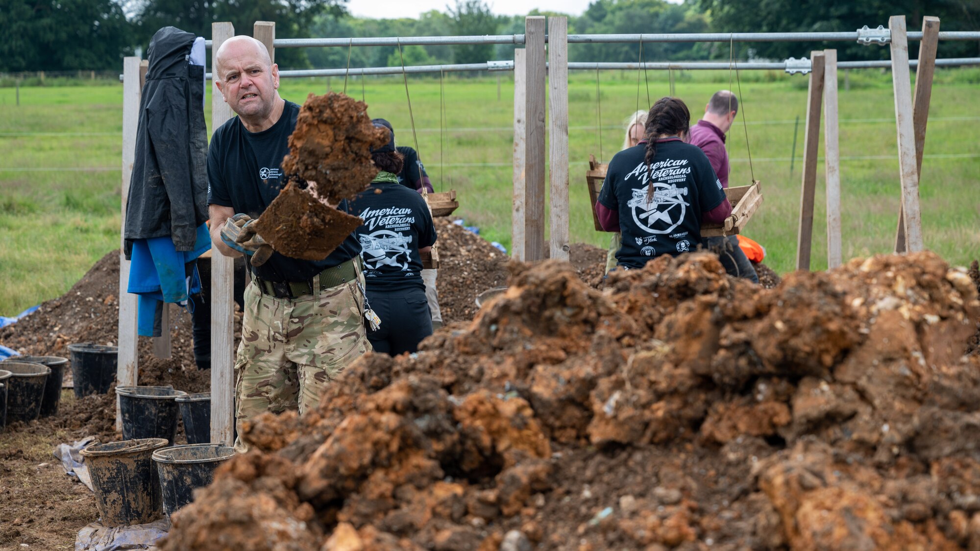 Julian Pitt, a British Navy veteran and volunteer with the American Veterans Archeological Recovery group, searches for remains of fallen service members during a B-24 Liberator excavation at Park Farm in Arundel, England, July 8, 2021. Seven Airmen from RAF Lakenheath had the opportunity to assist in the excavation and work with the AVAR team to recover the remains of these service members. (U.S. Air Force photo by Senior Airman Koby I. Saunders)