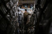 Staff Sgt. Dwayne Baldwin, 701st Airlift Squadron loadmaster, inspects cargo before departing to Johan Adolf Pengel International Airport, Suriname from Joint Base Charleston, South Carolina, July 16, 2021.