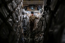Staff Sgt. Dwayne Baldwin, 701st Airlift Squadron loadmaster, inspects cargo before departing to Johan Adolf Pengel International Airport, Suriname from Joint Base Charleston, South Carolina, July 16, 2021.