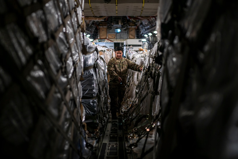 Staff Sgt. Dwayne Baldwin, 701st Airlift Squadron loadmaster, inspects cargo before departing to Johan Adolf Pengel International Airport, Suriname from Joint Base Charleston, South Carolina, July 16, 2021.