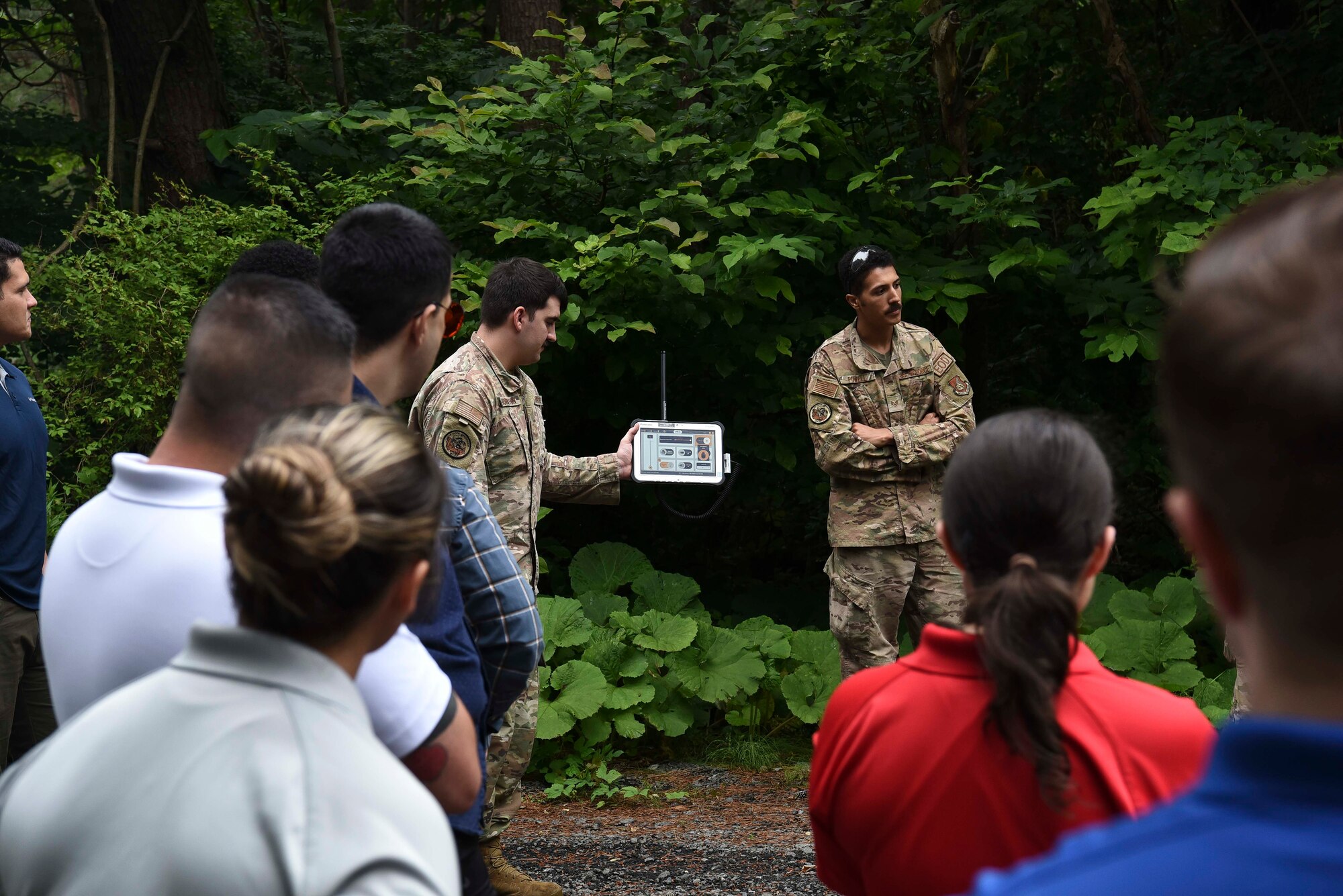 A military member holds a tablet with what looks like the home screen of the application. The device's purpose is to show an x-ray of a bomb.