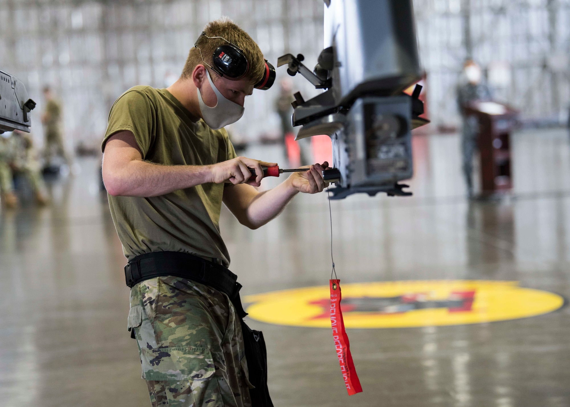 U.S. military members prepares munitions to be loaded and ready for an F-16.