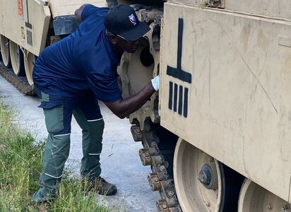 Dennis Hughes, a U.S. Army Tank-automotive and Armaments Command Logistics Assistance Representative assigned to Army Field Support Battalion-Germany, 405th Army Field Support Brigade, inspects an M1A2 Abrams tank as part of the recent divestiture mission for 1st Brigade, 1st Cavalry Division in Europe. The 405th AFSB’s Germany battalion signed for 62 major pieces of equipment to include nearly 58 M1A2 Abrams tanks and four M104 Wolverine heavy assault bridges. (U.S. Army courtesy photo)