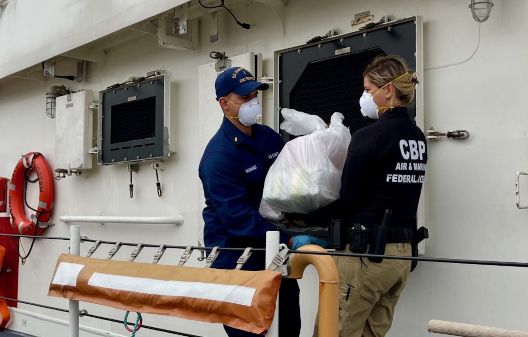 The crew of the Coast Guard Joseph Tezanos offloads nearly $15 million in cocaine and transfers custody of two suspected smugglers at Coast Guard Base San Juan July 12, 2021. Cutter Joseph Tezanos, with the assistance of a Customs and Border Protection (CBP) Air and Marine Operations (AMO) Multi-Role Enforcement Aircraft (MEA) aircraft, interdicted a go-fast vessel in Mona Passage waters July 10, 2021, which resulted in the apprehension of the smugglers and seizure of 502 kilograms of cocaine.  The interdiction resulted from multi-agency efforts in support of U.S. Southern Command's enhanced counter-narcotics operations in the Western Hemisphere and coordination with the Caribbean Corridor Strike Force (CCSF).  (U.S. Coast Guard photo).