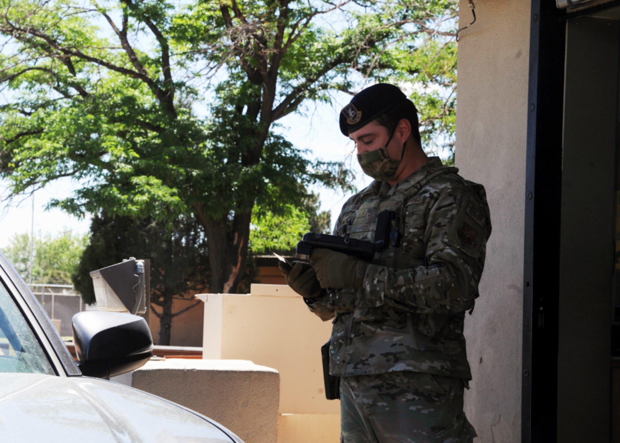 Air Force gate guard checks driver's ID card.