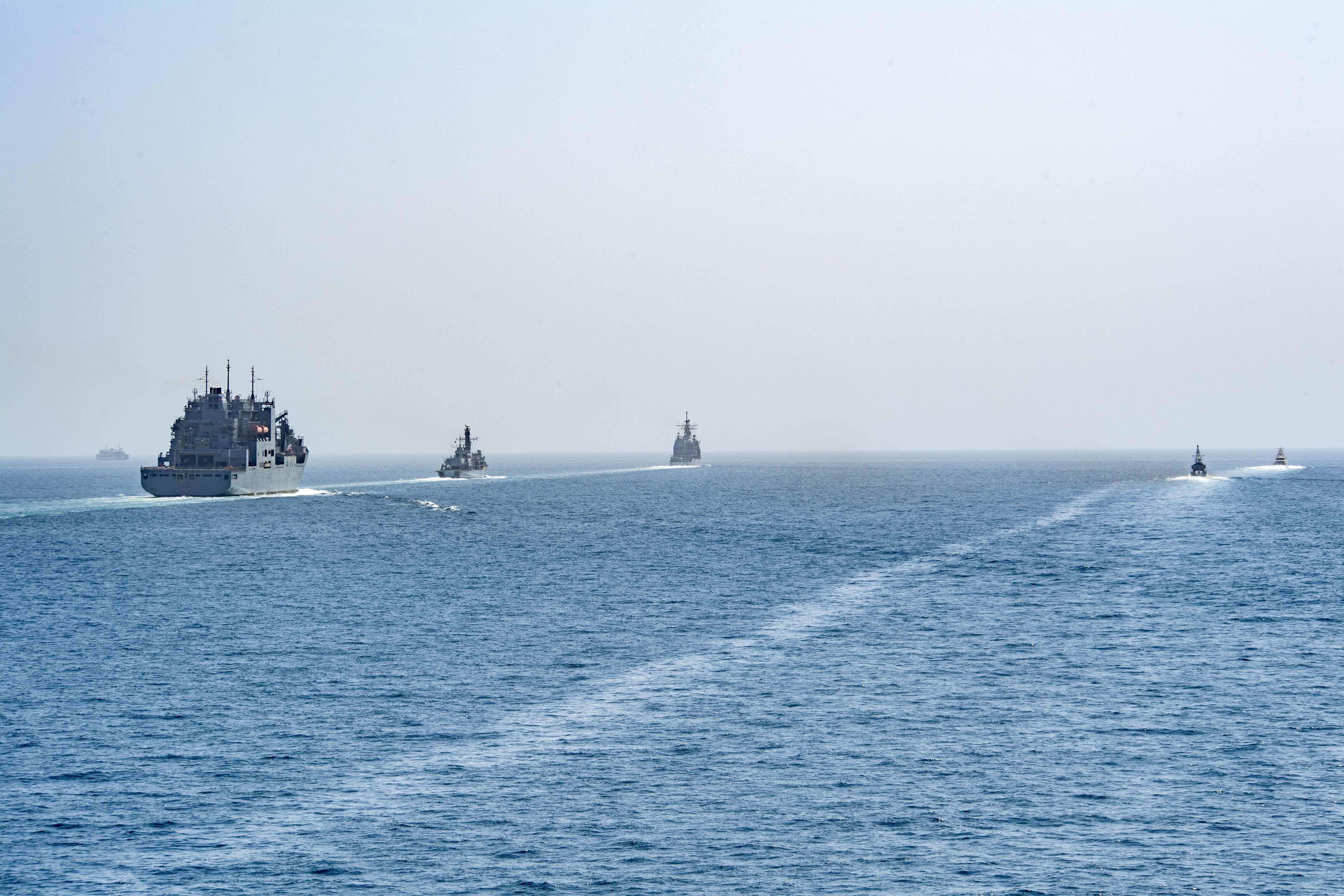 USNS Cesar Chavez (T-AKE 14), USS Whirlwind (PC 11), the Royal Navy frigate HMS Montrose (F 236), USS Monterey (CG 61), USCGC Charles Moulthrope (WPC 1141) transit the Strait of Hormuz.