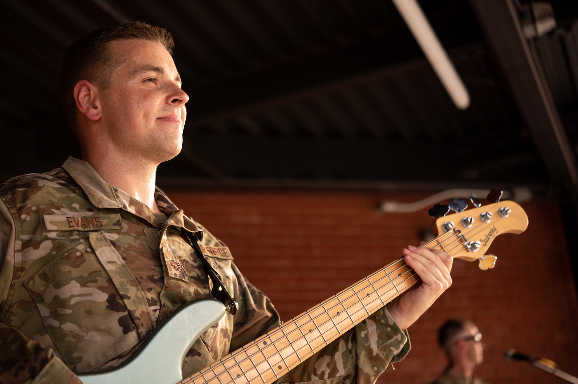 U.S. Air Force Staff Sgt. Simon Evans, USAF Band of Mid-America musician, plays the bass before a baseball game at Busch Stadium on St. Louis, Missouri, July 16, 2021. The USAF Band of Mid-America’s Starlifter band performs a wide range of musical styles including rock, pop, jazz and country, as well as traditional patriotic songs. (U.S. Air Force Photo by Airman 1st Class Isaac Olivera)