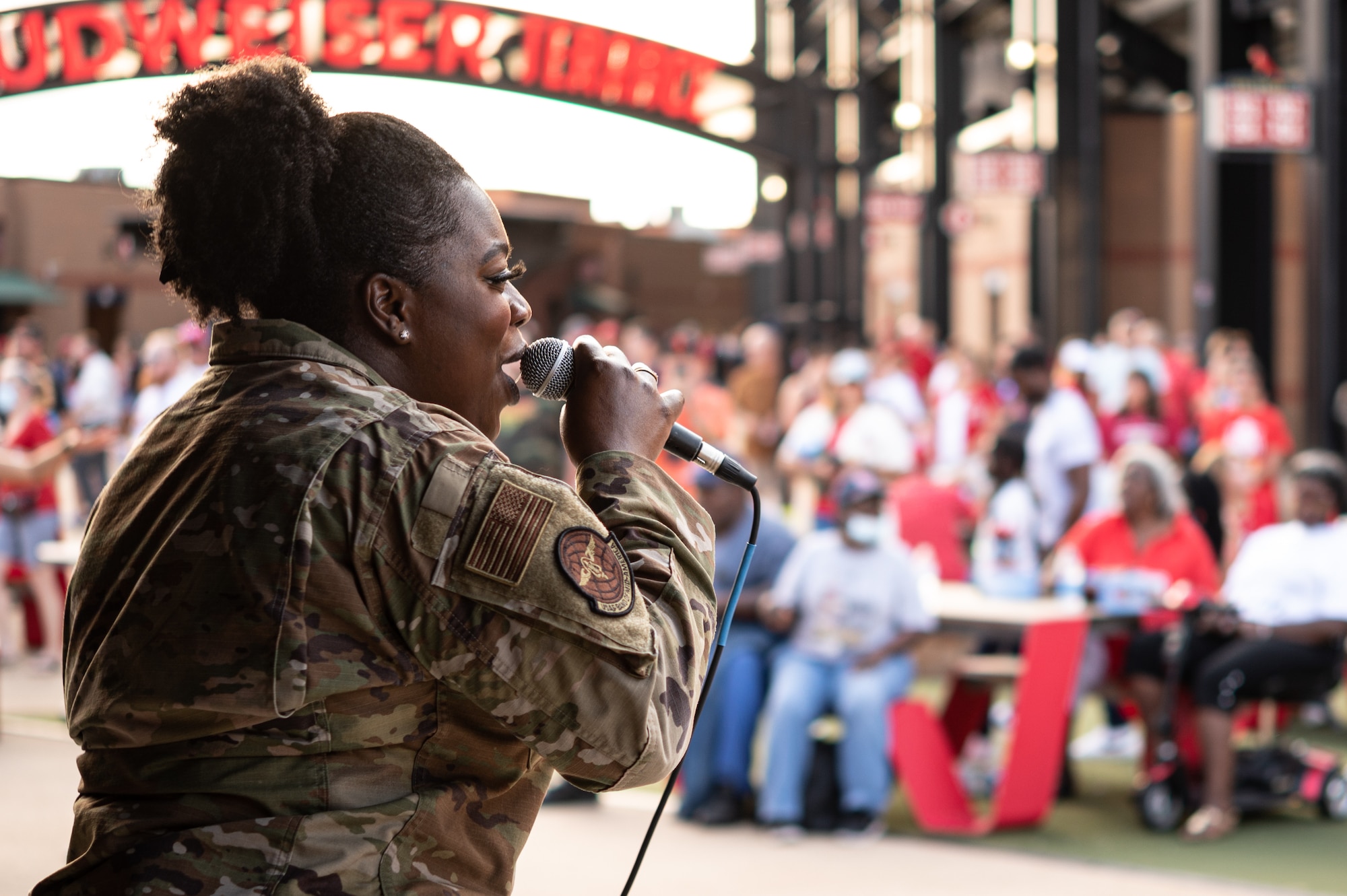 U.S. Air Force Staff Sgt. Paula Hunt, USAF Band of Mid-America musician, sings before a baseball game at Busch Stadium on St. Louis, Missouri, July 16, 2021. The USAF Band of Mid-America’s Starlifter band showcases Air Force excellence by performing throughout the Midwest. (U.S. Air Force Photo by Airman 1st Class Isaac Olivera)