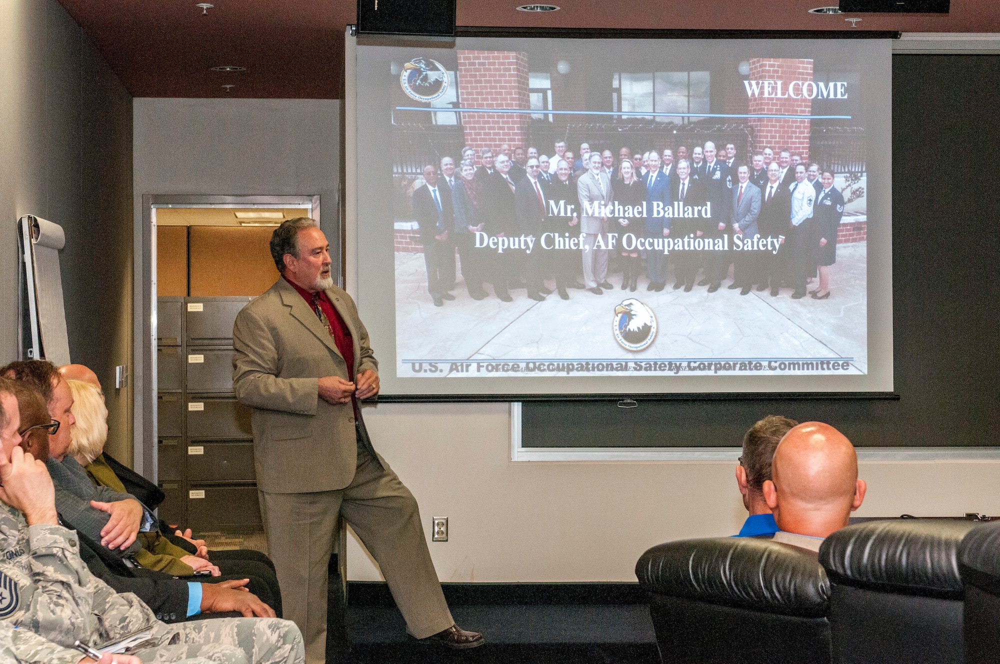 Ballard retires with more than 45 years of service. Photo of Ballard briefing the Occupational Safety Corporate Committee.