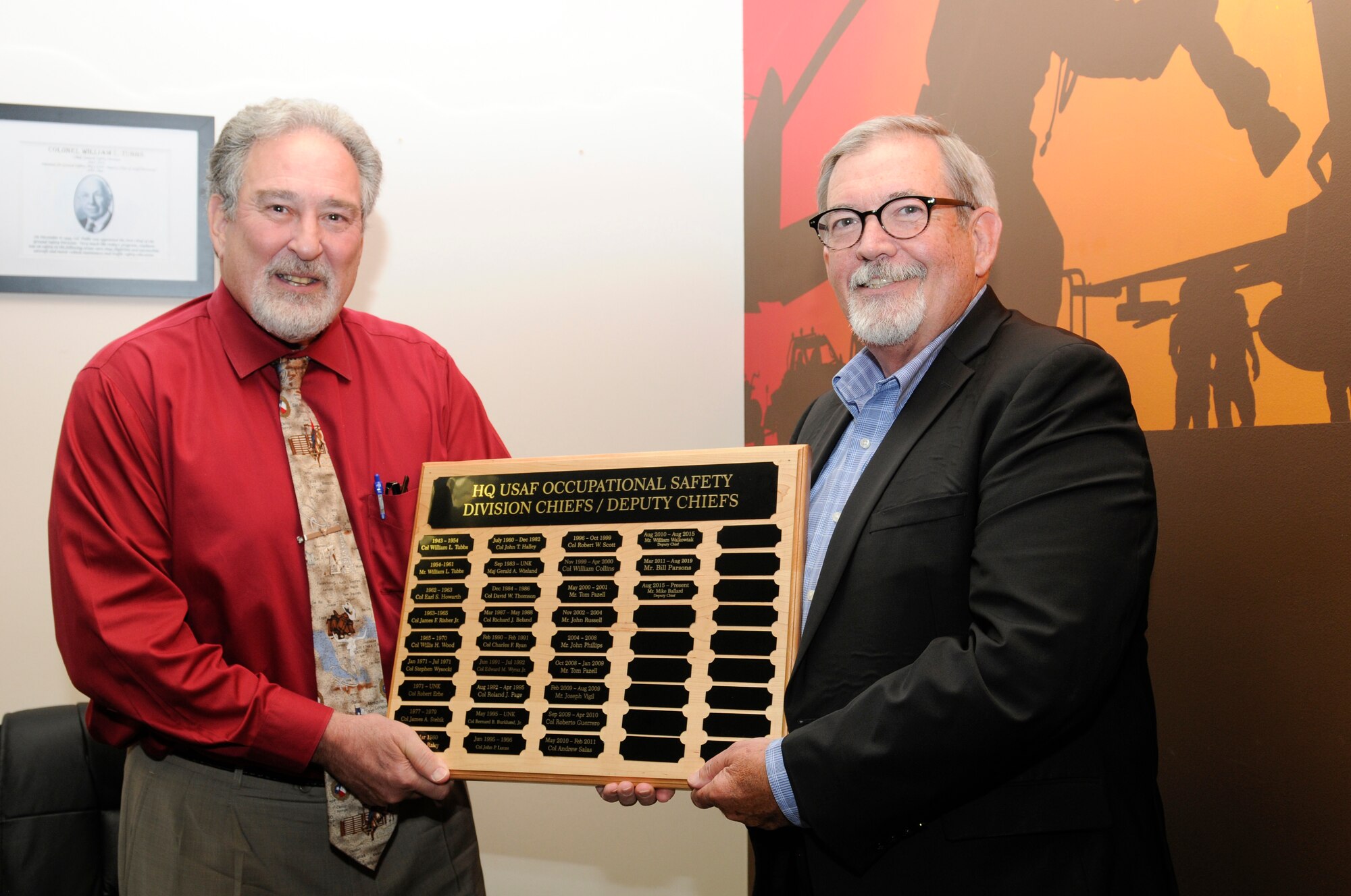 Ballard retires with more than 45 years of service. Photo of Ballard and Parsons holding plaque.