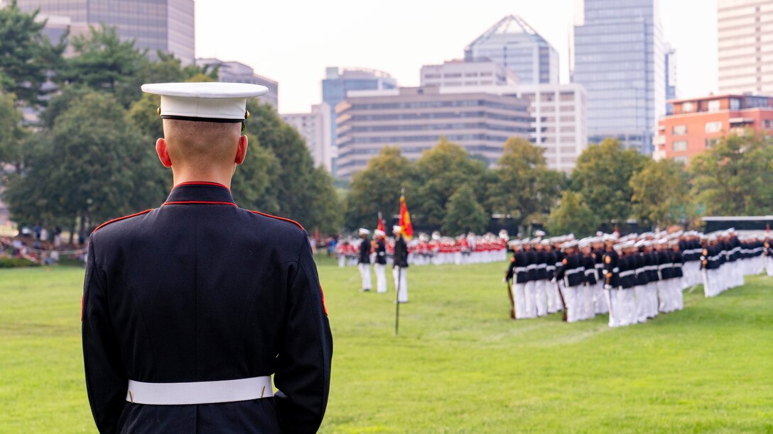 A hoster watches as the companies “Fix bayonets” during a Tuesday Sunset Parade at the Marine Corps War Memorial, Arlington, VA, June 15 2021. The guest of honor for the evening was Ms. Kimberly Jackson, Deputy Assistant Secretary of Defense for Force Readiness, and Brig. Gen. Peter D. Huntley, Director, Operations Division, Plans, Policies and Operations, was the hosting official. (U.S. Marine Corps photo by Sgt. Jason Kolela)